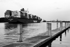 Tim Barnwell  -  2423, Cargo ship sailing out of Savannah River, GA-concrete pier foreground /   -  