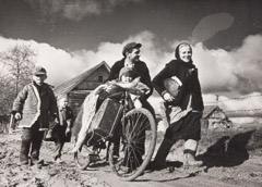 V. Grebnev  -  Driver Georgi Iosigovich, His Wife and Children, returning to their home n the Kalinin  Region, 1944 / Silver Gelatin Print  -  5 x 7
