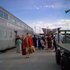 Vivian Maier  -  Location and date unknown, (woman & train) / Chromogenic Print  -  12 x 12 on 16 x20 paper