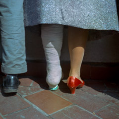 Vivian Maier  -  Location and Date unknown, (cast and red shoe) / Chromogenic Print  -  12 x 12 on 16 x20 paper