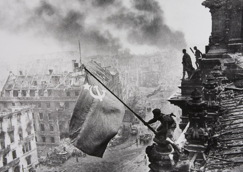 Soldier Raising The Soviet Flag Over The Reichstag