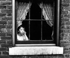 Peter Sekaer  -  Child in Window, Louisville, Kentucky, n.d. / Silver Gelatin Print  -  9 5/8 X 11 3/8 