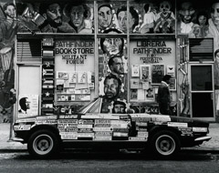 John Gutmann  -  Che Guevara, Malcom X, Rosa Luxemburg, et al at the Militant Forum Bookstore with Slogan Car. San Francisco, 1988 /   -  11x14 