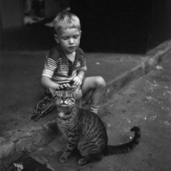 Vivian Maier  -  1954, (boy & cat), New York, NY / Silver Gelatin Print  -  12 x 12 (on 16x20 paper)