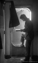 Harold Feinstein  -  GI Reading in Shipboard Doorway, 1952 /   -  