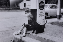 Dorothea Lange  -  Girl Reading at Gas Pump with Dog, 1956 / Silver Gelatin Print  -  