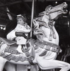 Ruth-Marion Baruch  -  Girl Riding Carousel Horse, San Francisco, 1948 / Silver Gelatin Print  -  