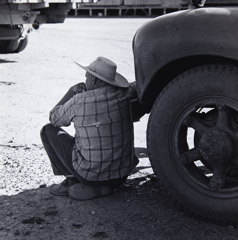 Pirkle Jones  -  Man Resting In Shade of Truck, Walnut Grove, 1961 /   -  